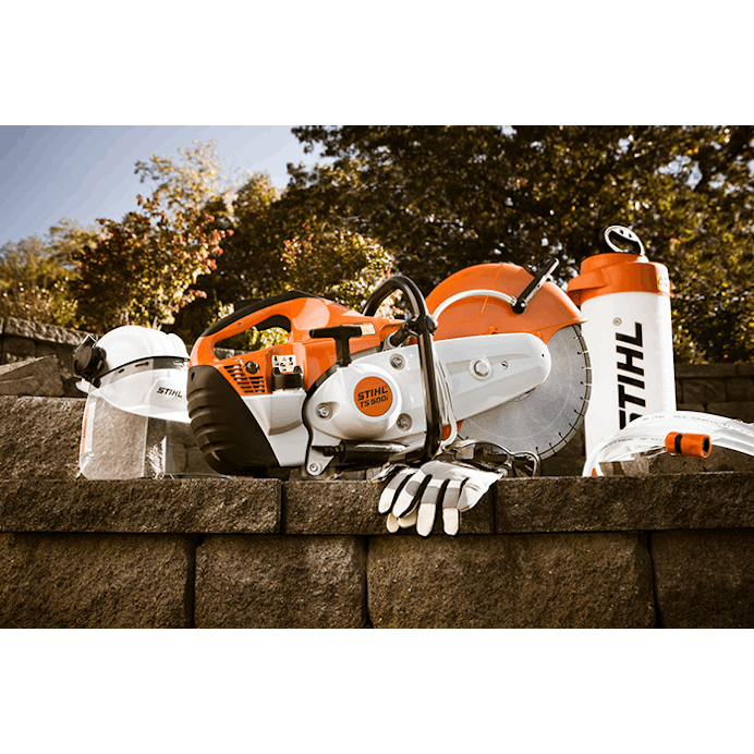Side view of TS 500i STIHL Cutquik® positioned next to STIHL protective wear