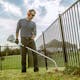 Man using STIHL FS 50 C-E to trim along fence line