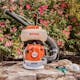 SR 200 in front of a flowery bush next to STIHL protective apparel 