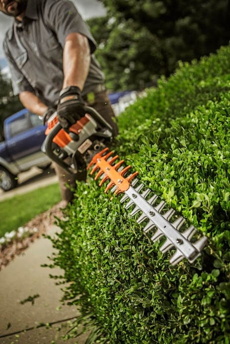 Close up of HS 82 R trimming a hedge
