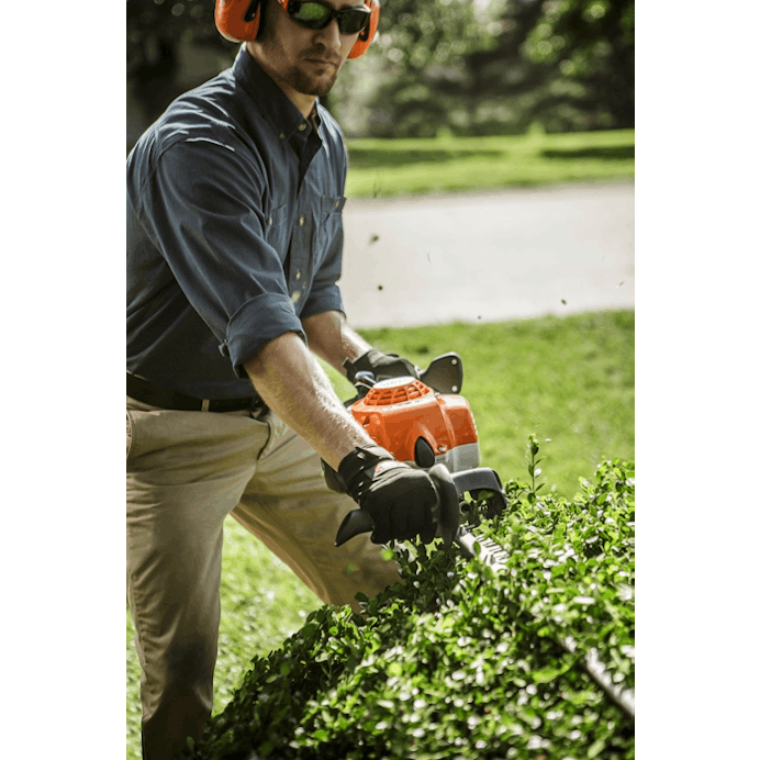 Man trimming hedge using the HS 87 T