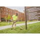 Man trimming grass near a sign using the FS 131 R