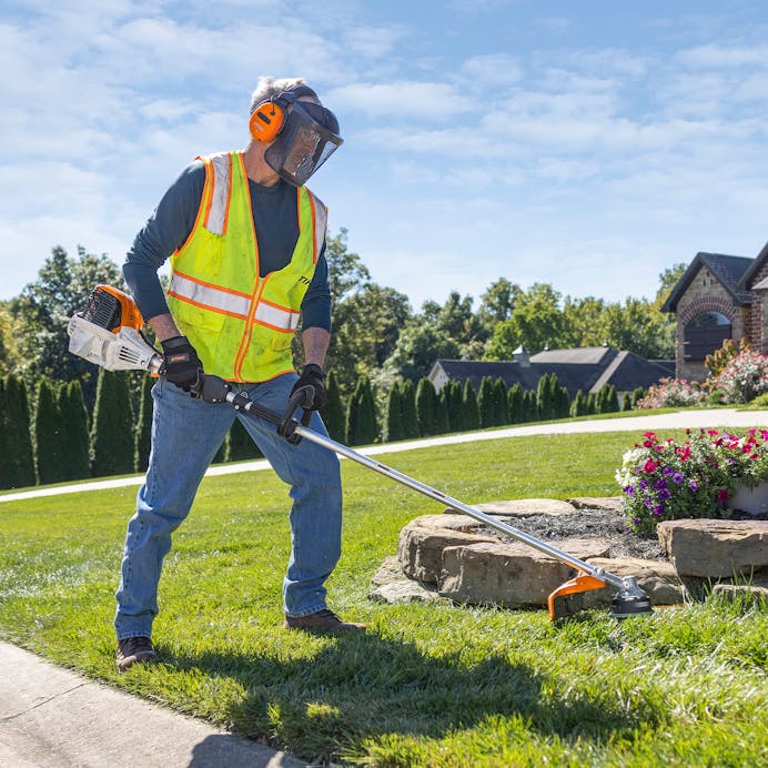 Man trimming rock edge with STIHL FS 111 RX