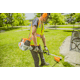 Man in a park trimming grass near bench using the KM 91 R