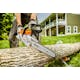 A man holding MSA 120 Chainsaw cutting a log 