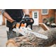 Man cutting log with close up of MSA 120 chainsaw