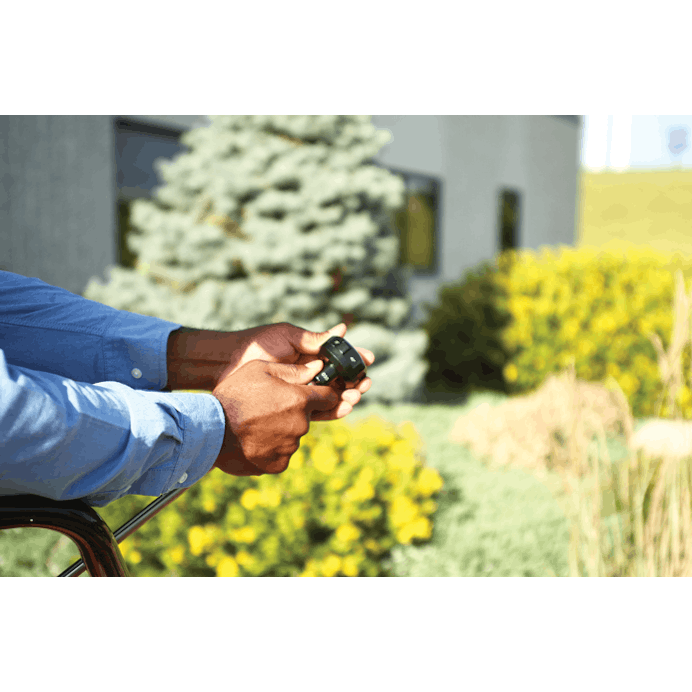 Man attaching multi-function nozzle to pressure washer