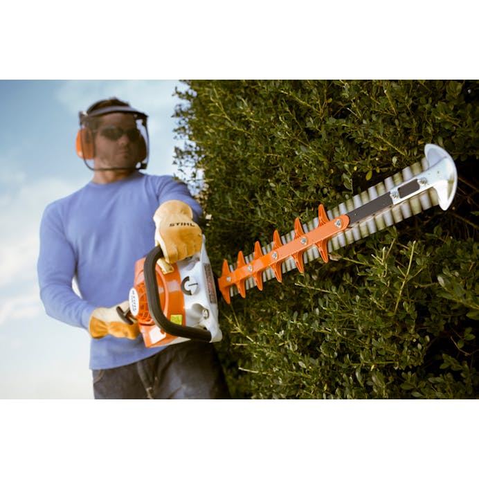 Man trimming side of hedge with the STIHL HS 56 