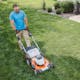 Aerial view of man cutting front lawn with STIHL RMA 510 V