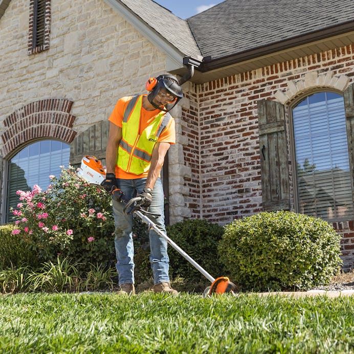 Man assembling KMA 153 R with trimmer attachment