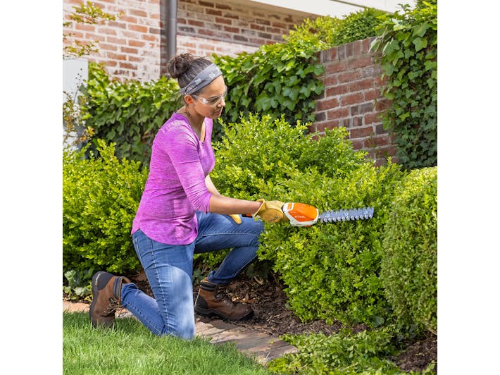 	Woman trimming a bush with HSA 26