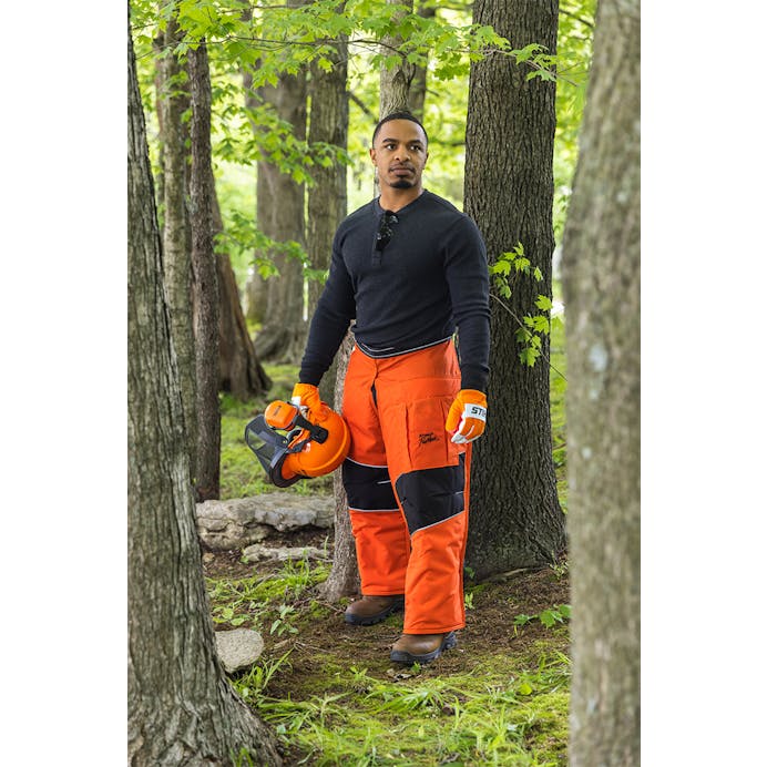 Man in Personal Protective Equipment standing in a forest