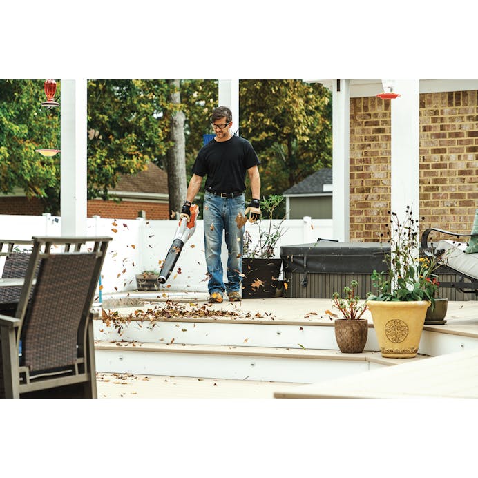 Man blowing leaves off deck with the BGA 60