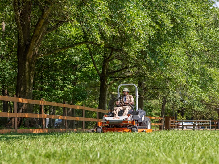 Man mowing lawn with STIHL RZ 972i K