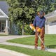	Man using FCA to edge sidewalk grass in STIHL PPE