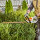 Close up of man trimming hedges with HSA 40