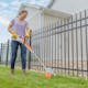 Woman trimming grass along fence with STIHL FSA 30