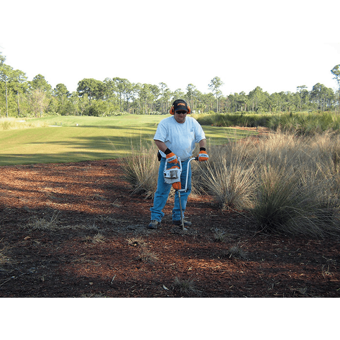 Man using BT 45 on dirt patch next to golf course