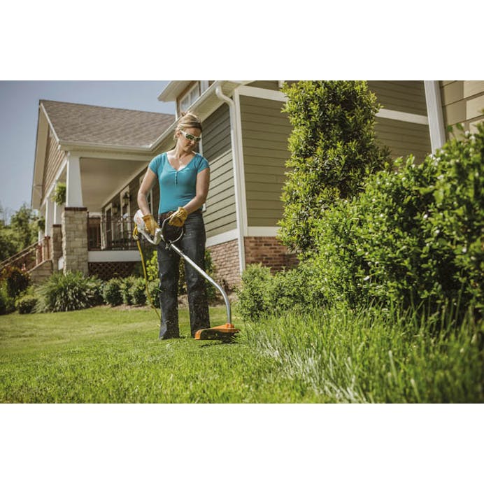 Woman trimming front yard with the FSE 60