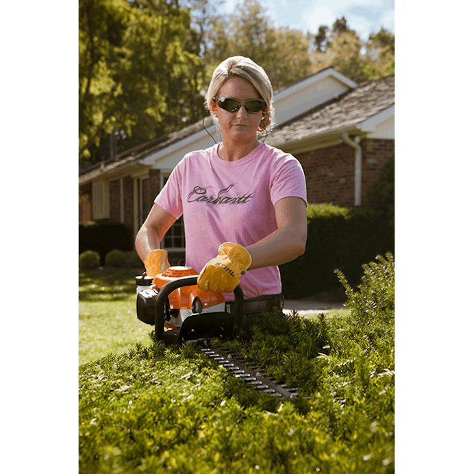 Woman trimming hedge using the HS 45 