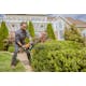 Man trimming hedges in garden using the HS 45 