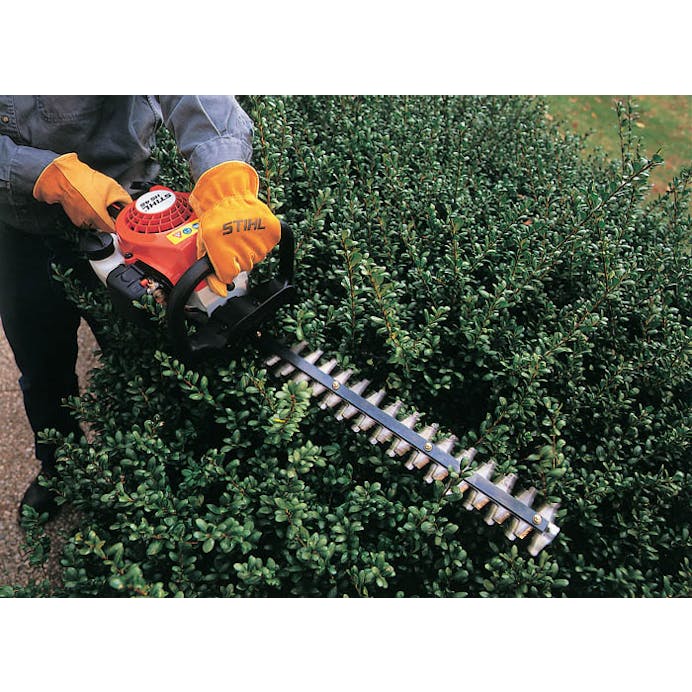 Close up of HS 45 being used to trim a hedge