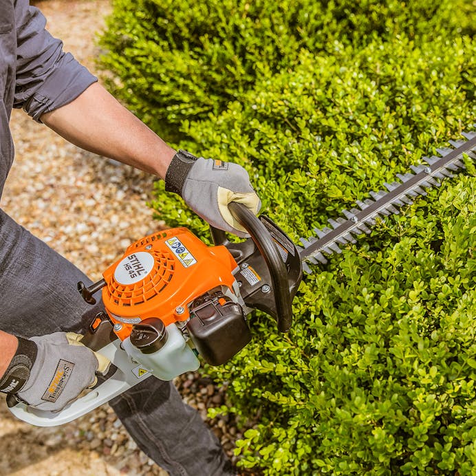 Close up of man trimming hedge with the HS 45