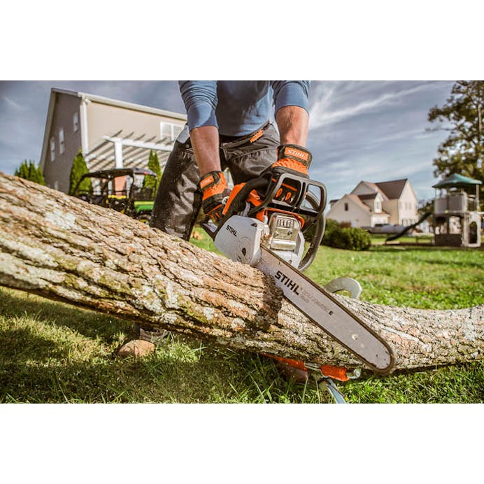 Close up of man cutting log with STIHL MS 180 C-BE Chainsaw