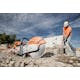 TS 800 STIHL Cutquik® resting on gravel while man breaks up rock in the background 
