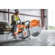 Man sitting on wood panels with the TS 800 STIHL Cutquik® on the floor in front of him