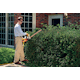 Man trimming hedge on side of house using the HSE 70