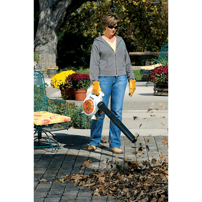 Woman blowing leaves off of patio with the BG 56 C-E