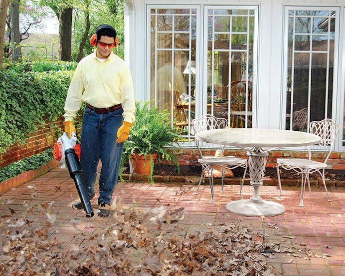Man blowing leaves off patio with the BG 66 L