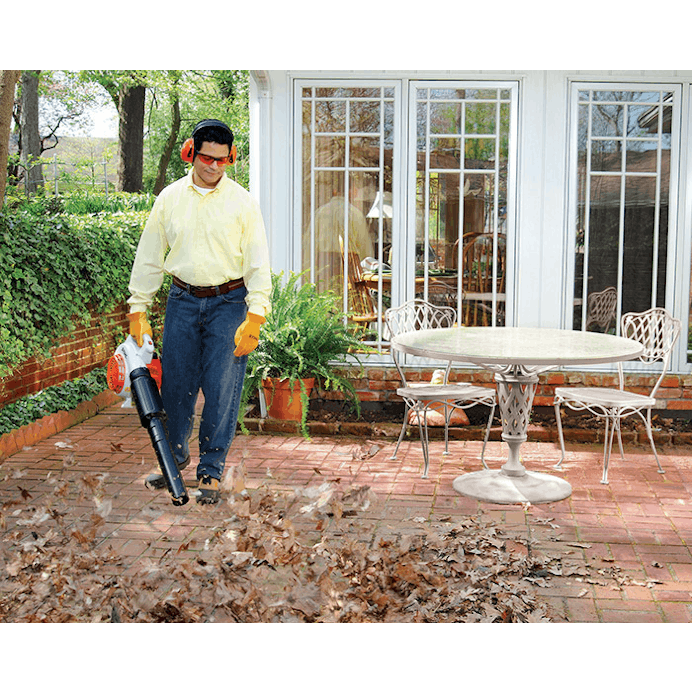 Man blowing leaves off patio with the BG 66 L