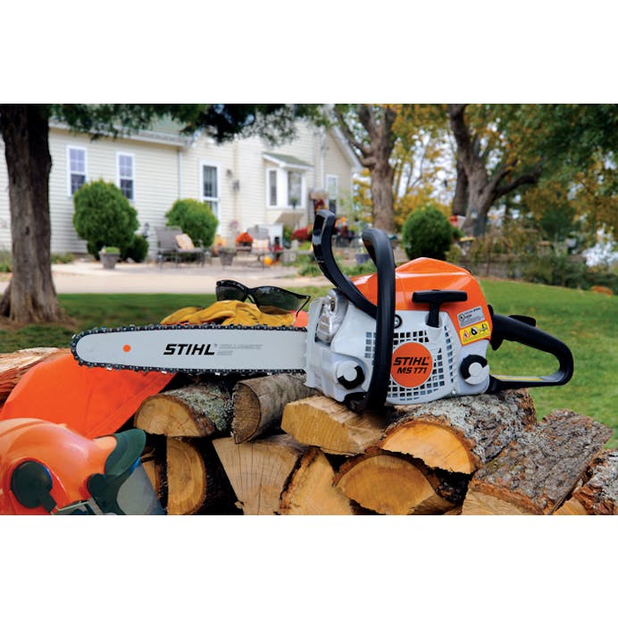 STIHL MS 171 Chainsaw resting on a pile of cut wood 