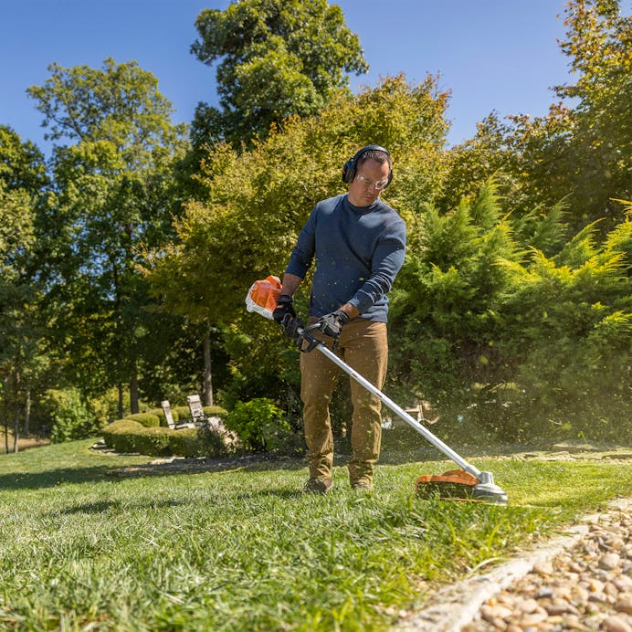 Man trimming lawn using the FS 70 R