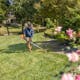 Wide shot of man using FS 70 R to trim lawn