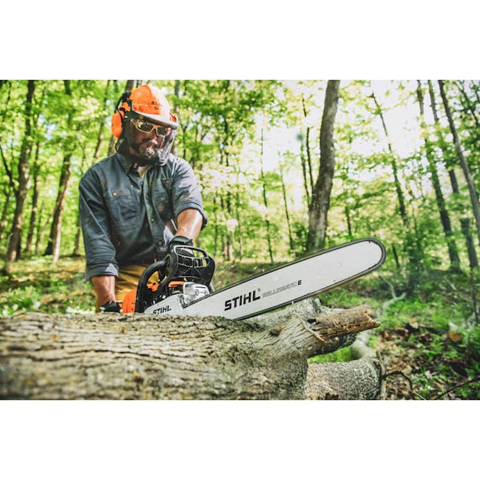 Man in the woods cutting log with MS 391