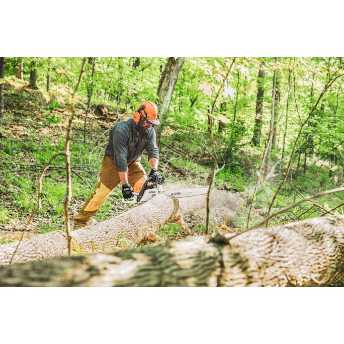 Wide shot of man cutting log with MS 391
