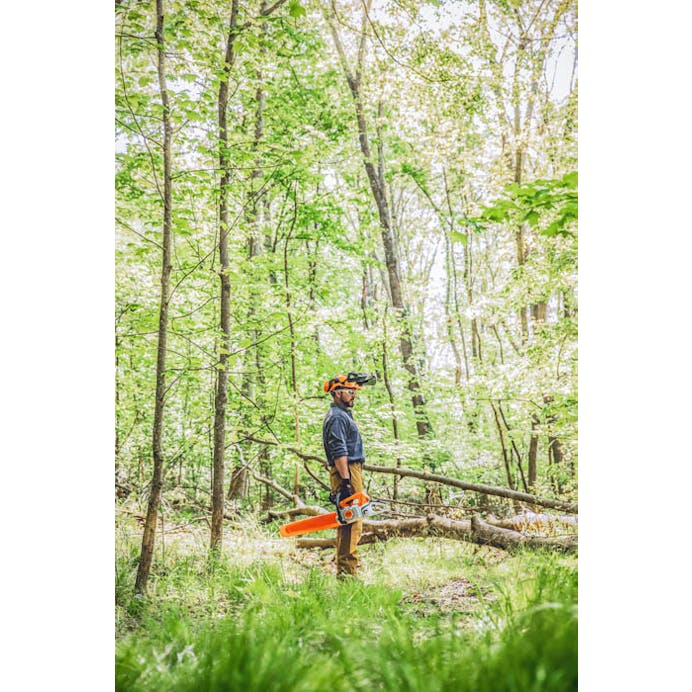 Wide shot of man holding MS 391 in the woods