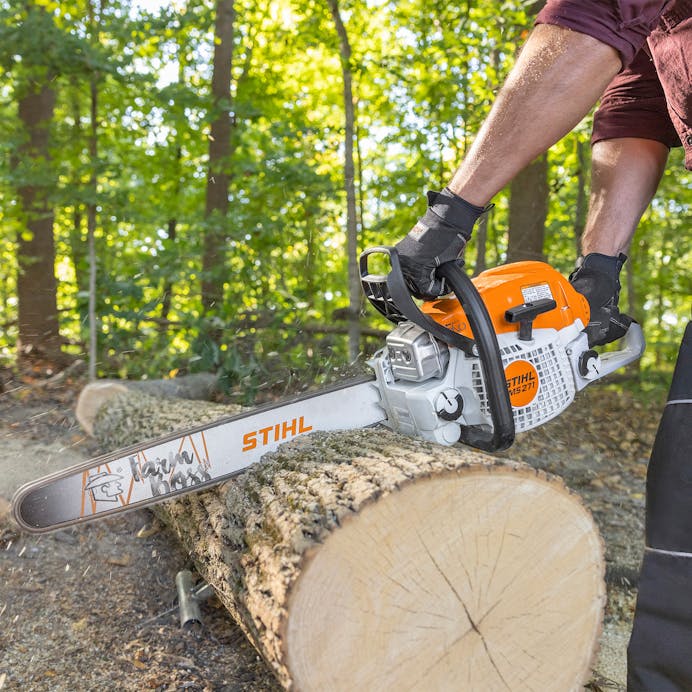 Close up of man cutting log with MS 271 FARM BOSS®